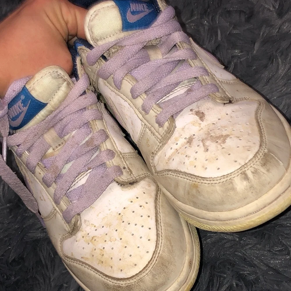 Well worn women’s Nike White dunks sneakers with Light Purple Accents WW
